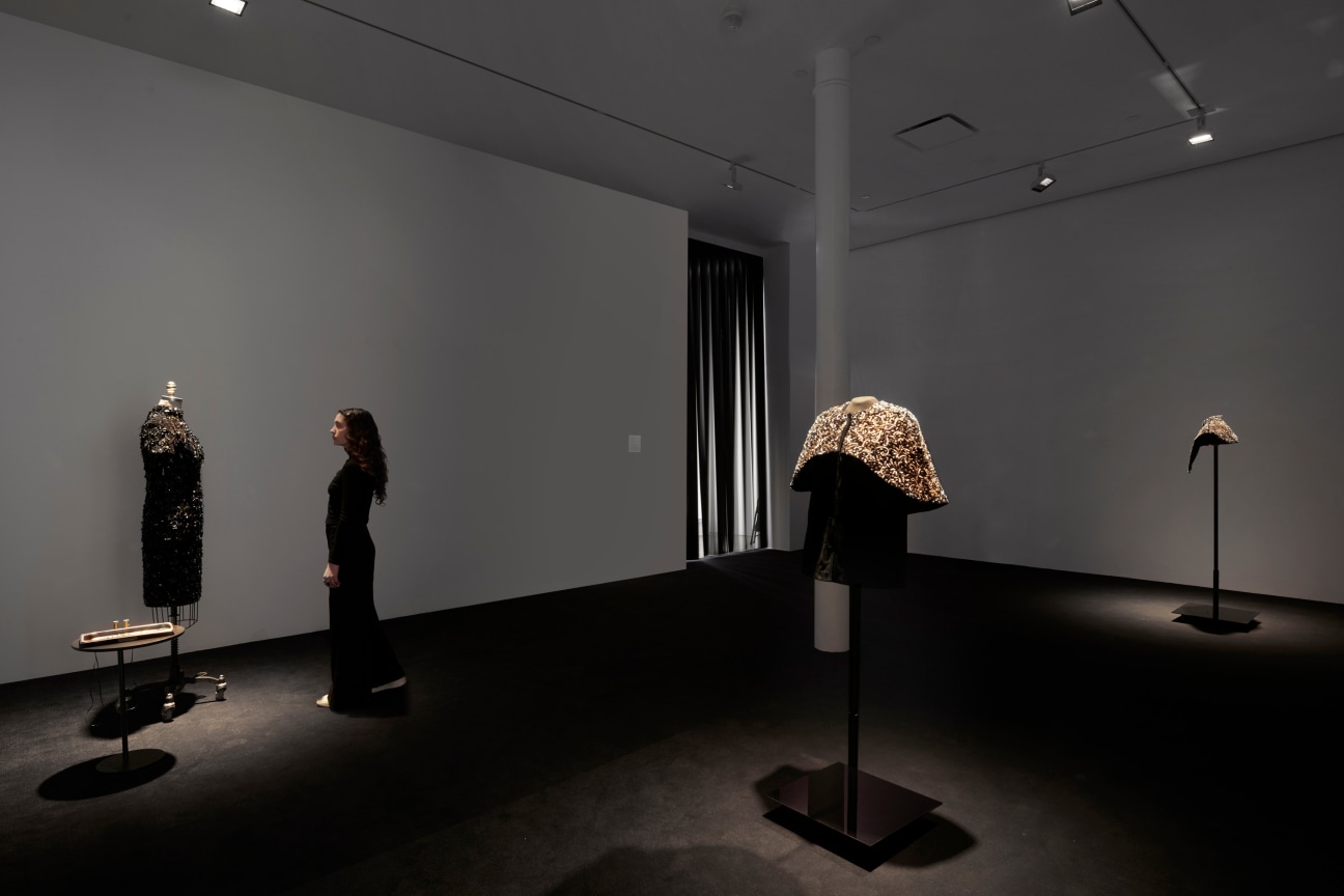 a dimly lit room with three items of clothing