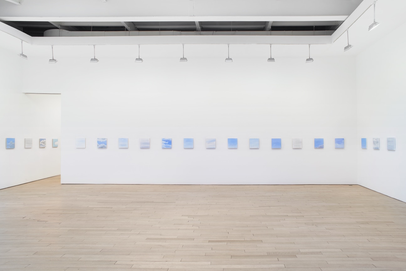 installation view of several square canvases in a row
