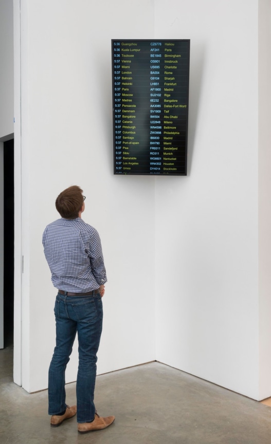 man observing a screen as artwork