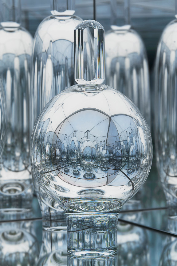 close up of a glass sculpture showing the reflection of the other glass sculptures surrounding it