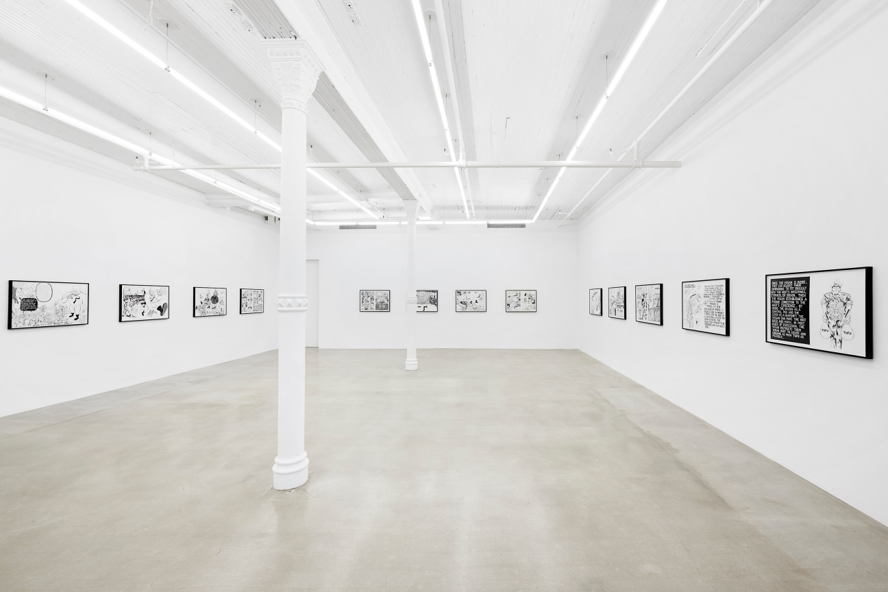 a row of black and white artwork spanning three walls