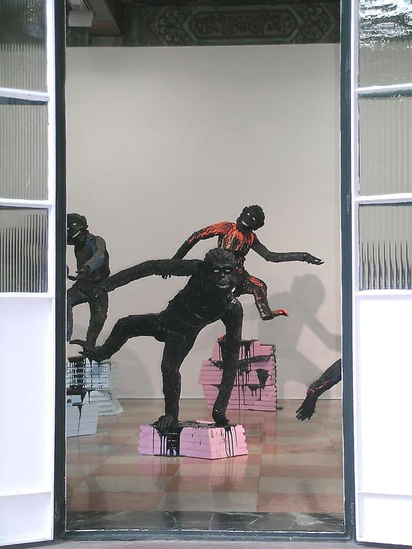 apes standing on pink and blue pedestals