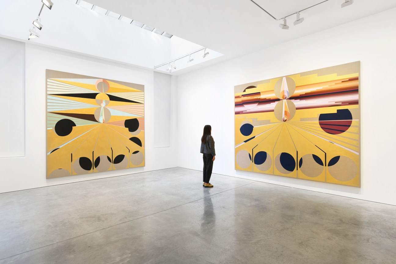 person looking at one of two paintings