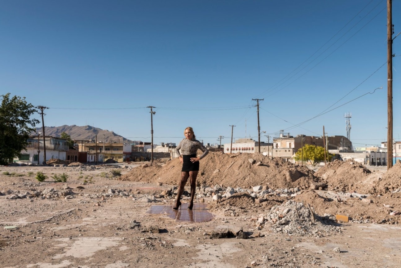 Transgender sex worker standing on the ruins of the dance floor of a demolished nightclub