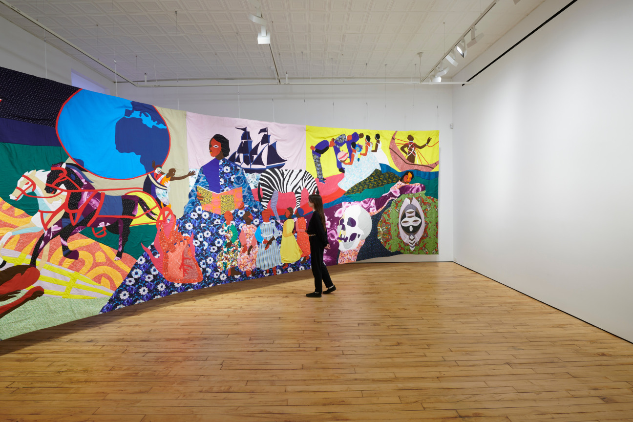 person looking at large tapestry