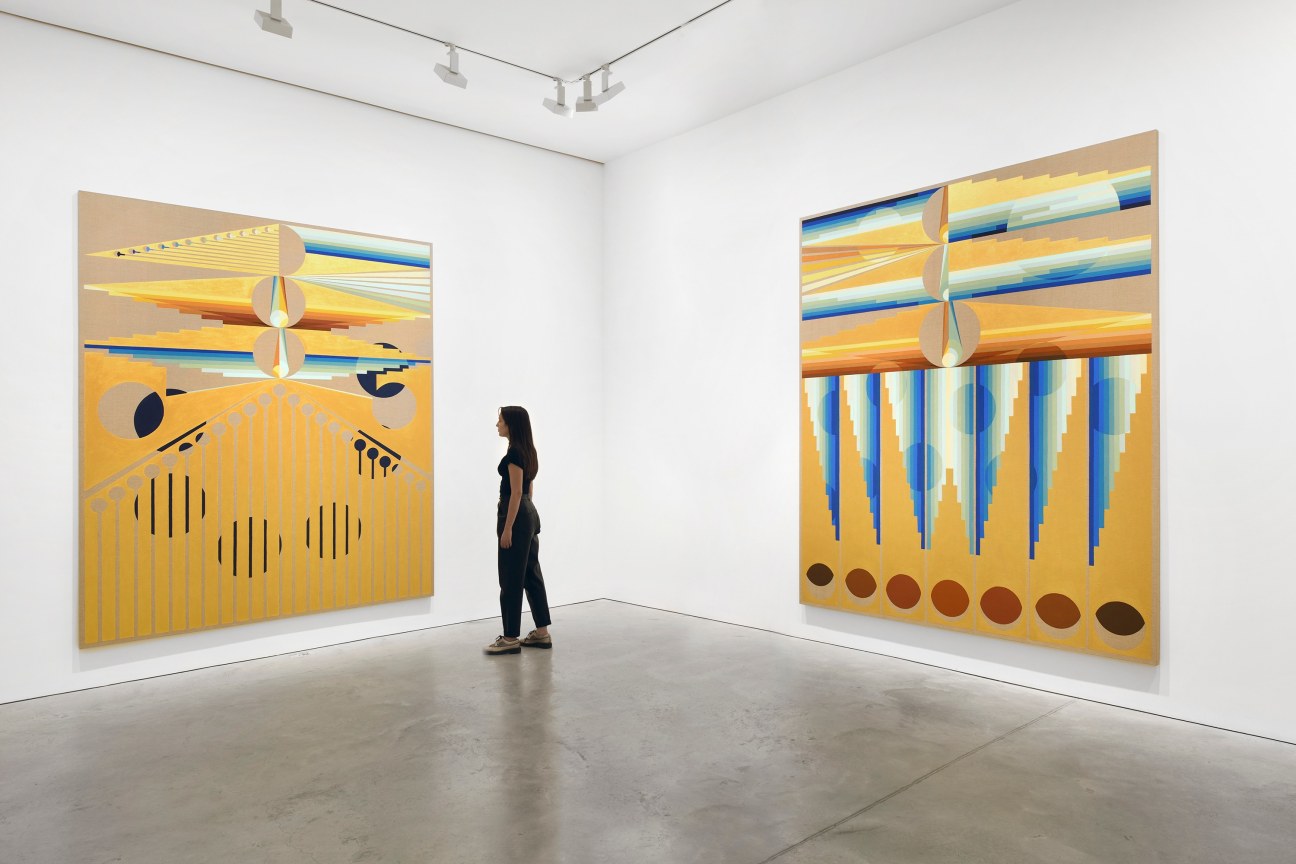 person looking at one of two paintings