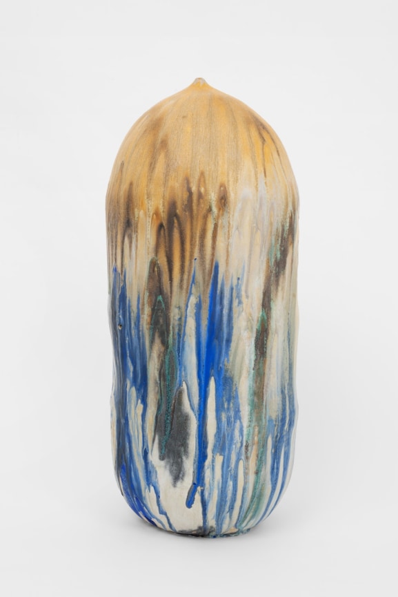 tall ceramic pot in varying shades of white, blue and tan