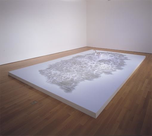 an artwork that looks like dirty snow on a white platform