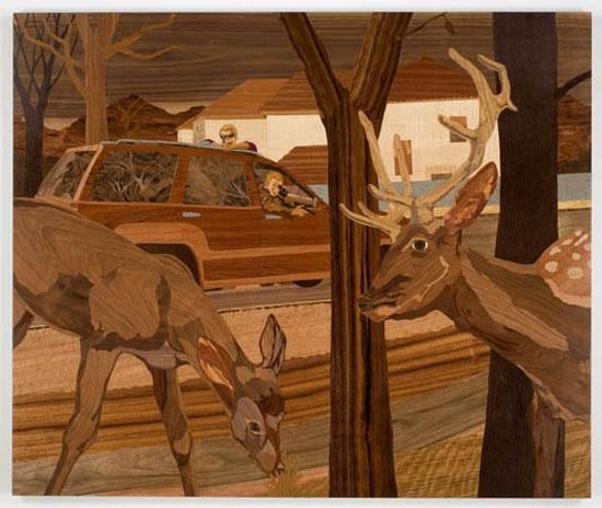 deer grazing while a car is behind them