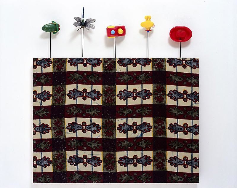 painting on textile with small toys attached to its borders