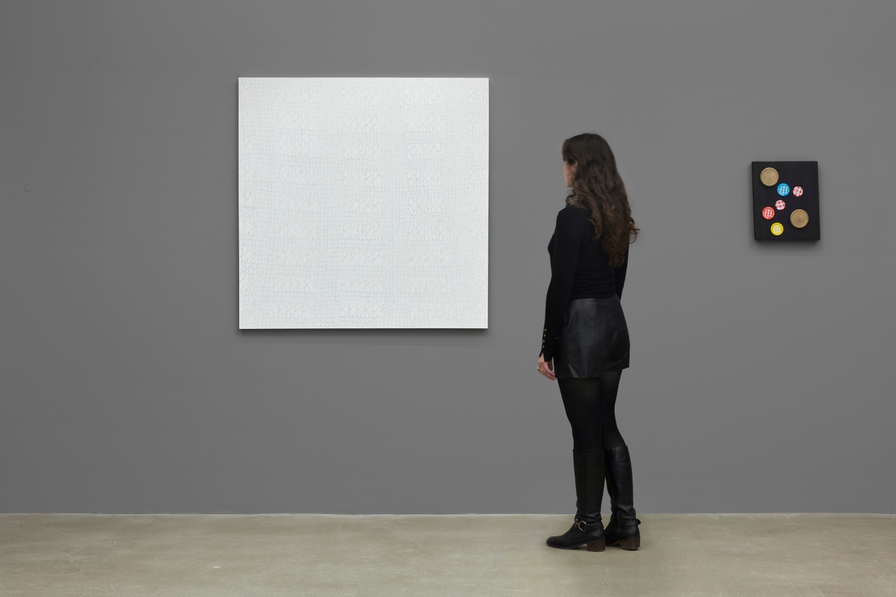 person observing a white artwork