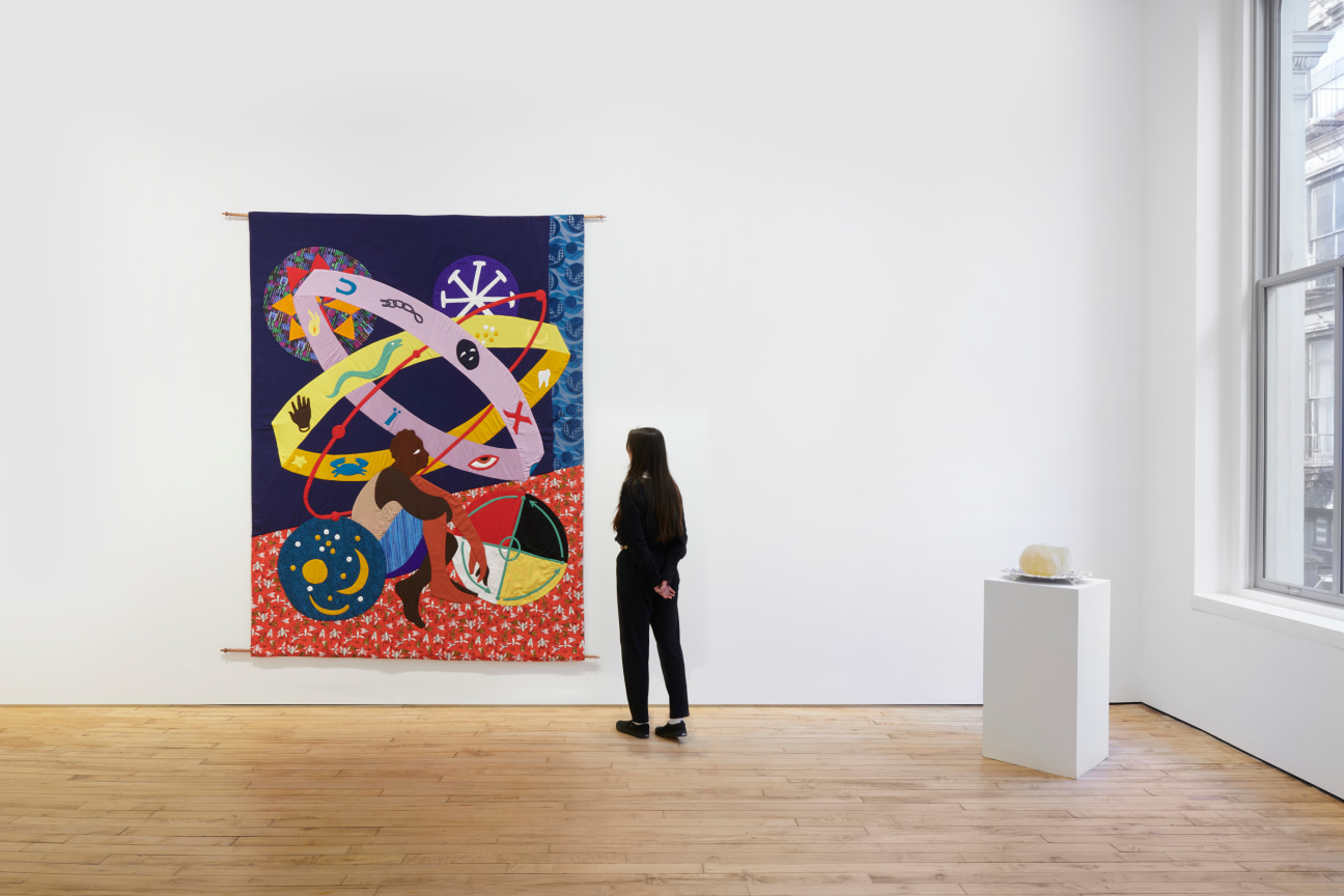 person looking at a tapestry