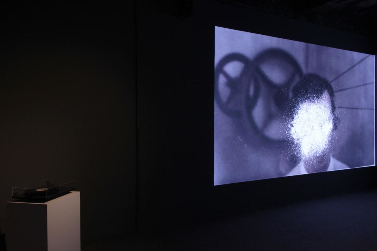 video projection next to a modern record player