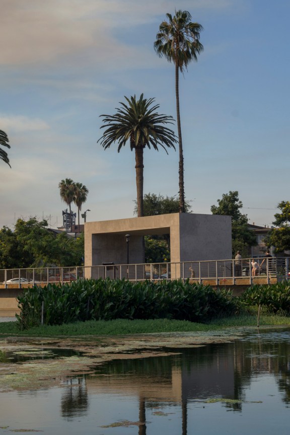 concrete structure facing a marsh-like landscape in a suburban area