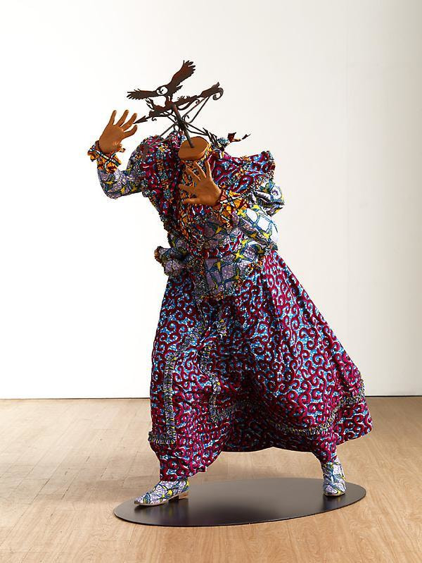 a mannequin with a weathervane for a head appearing to be walking against the wind