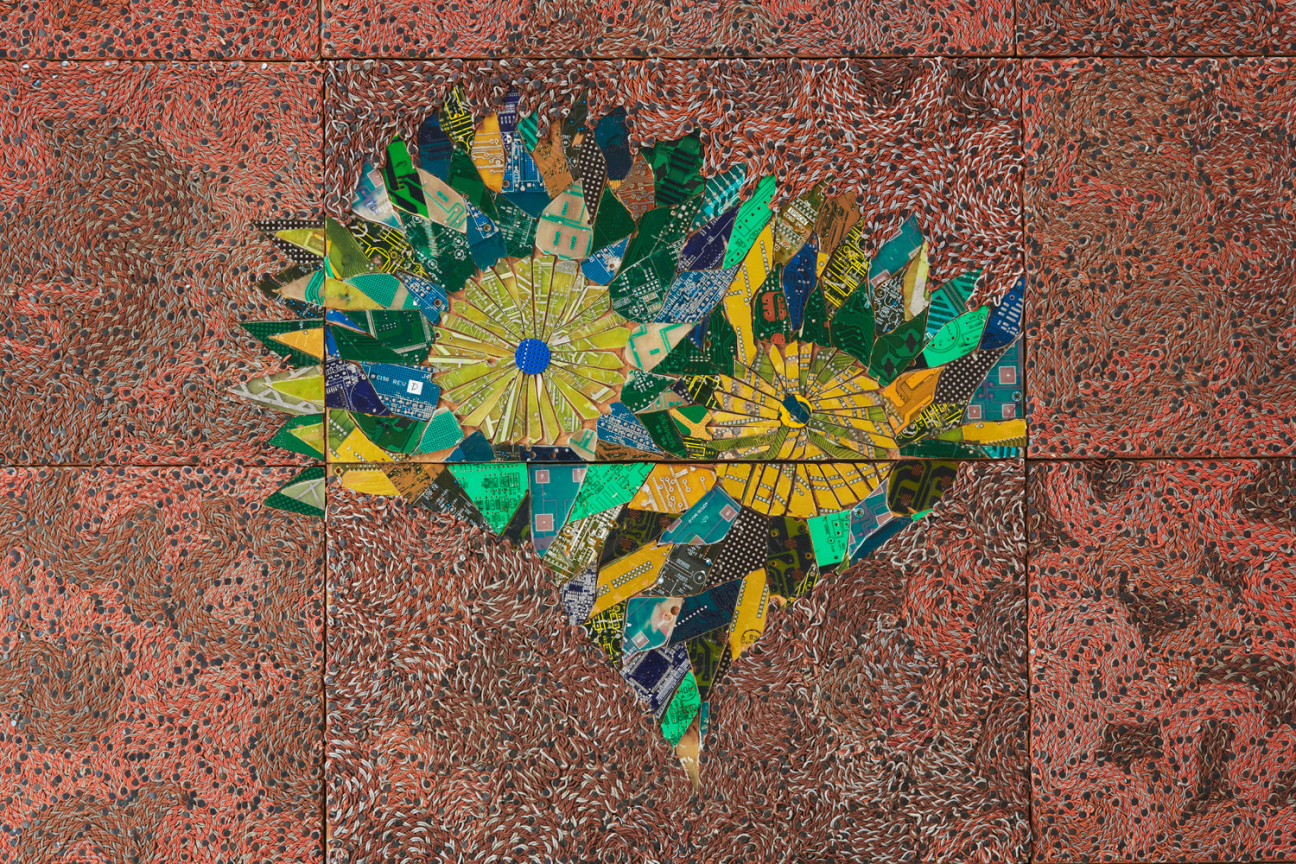 flowers composed of electrical components surrounded by swirling red electrical wires