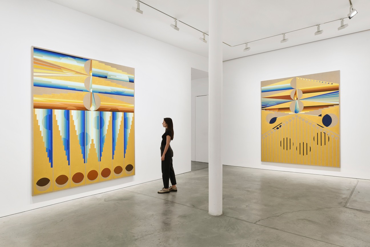 person looking at one of two paintings