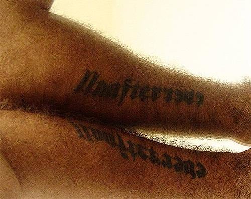 tattooed limb reflecting against a mirror