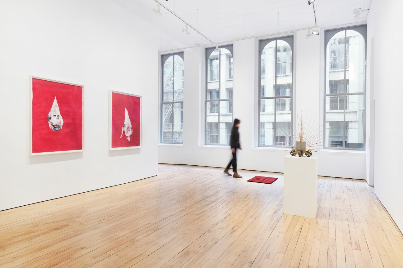 person walking amongst different artworks