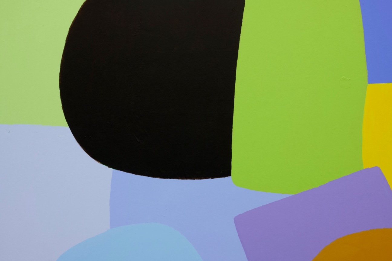 Close up of Federio Herrero's &quot;Visita&quot; focusing on a rounded, black shape surrounded by green and purple geometric shapes