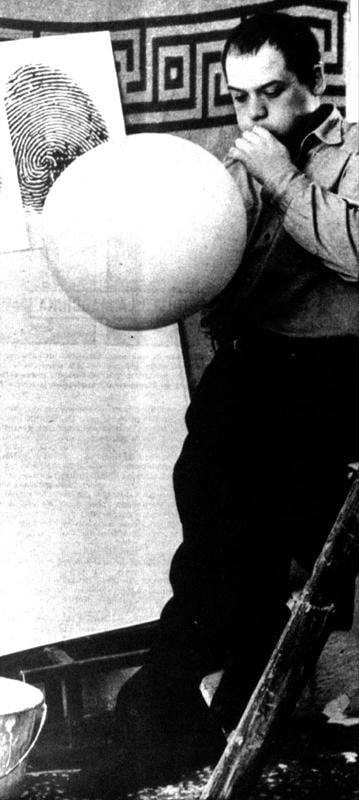 image of artist blowing into a balloon