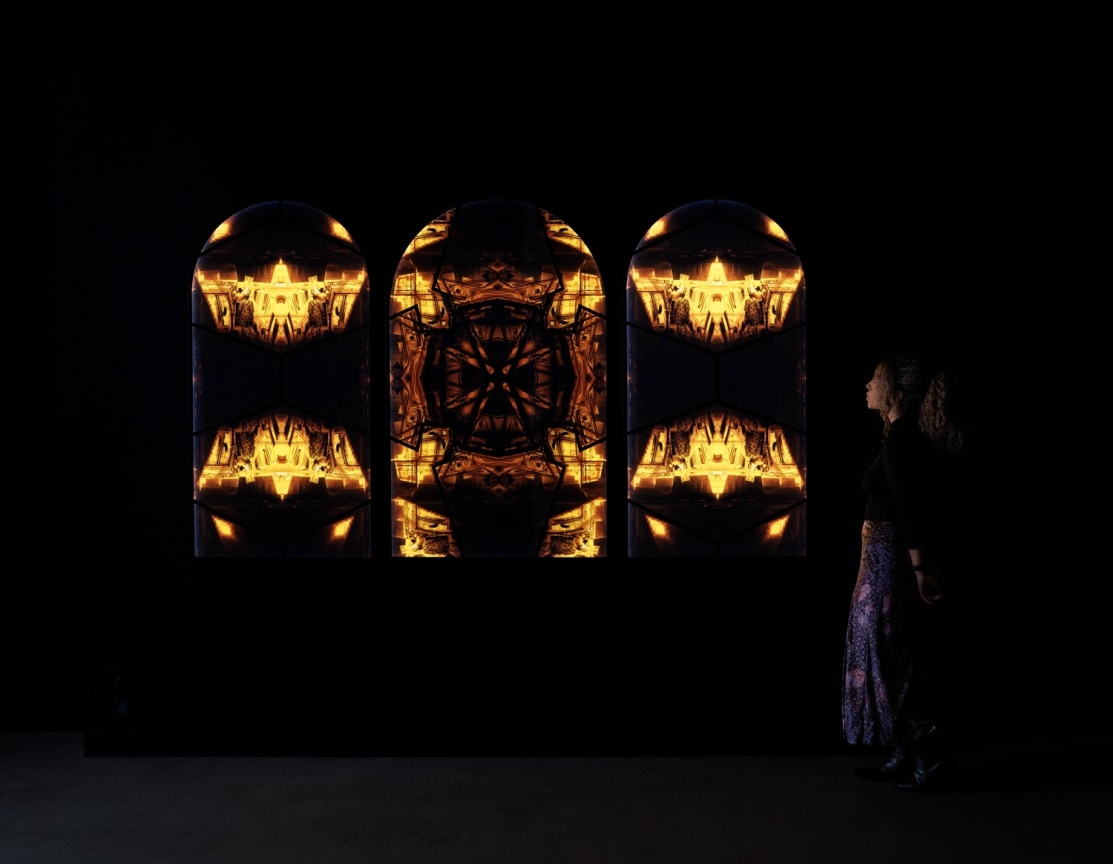 person viewing at artwork in the dark