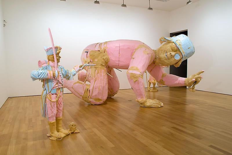 installation view of several statues, including a very large one