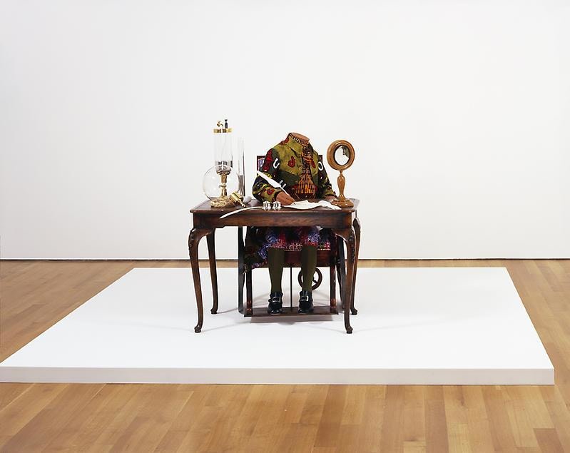 mannequin in a wheelchair writing