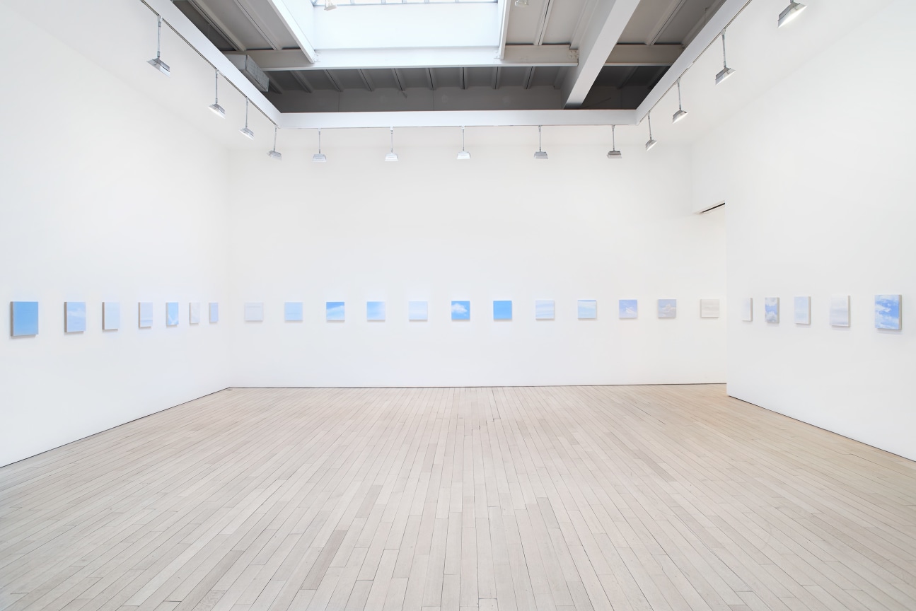 installation view of several square canvases in a row