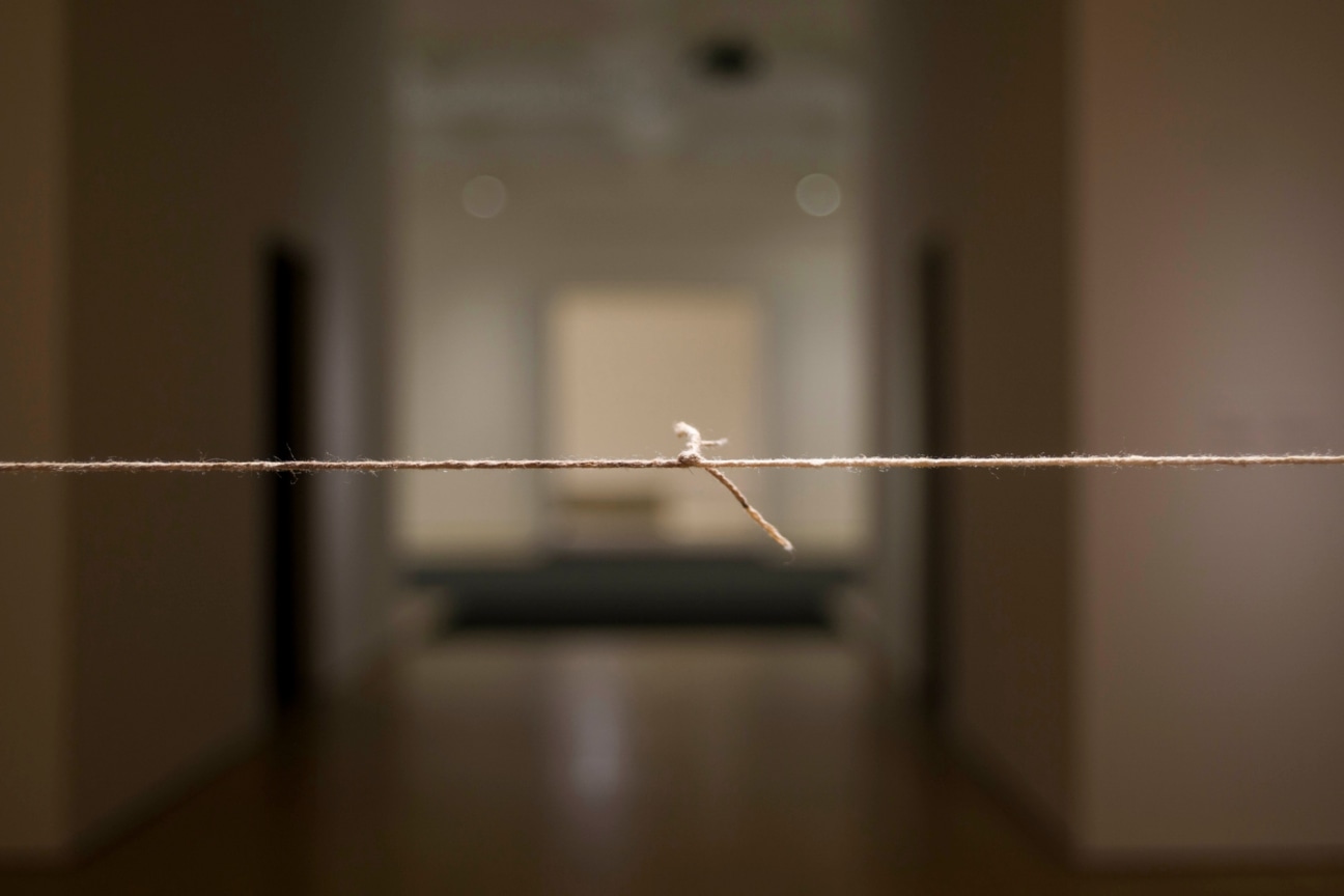 thread suspended in mid air with a knot in the center