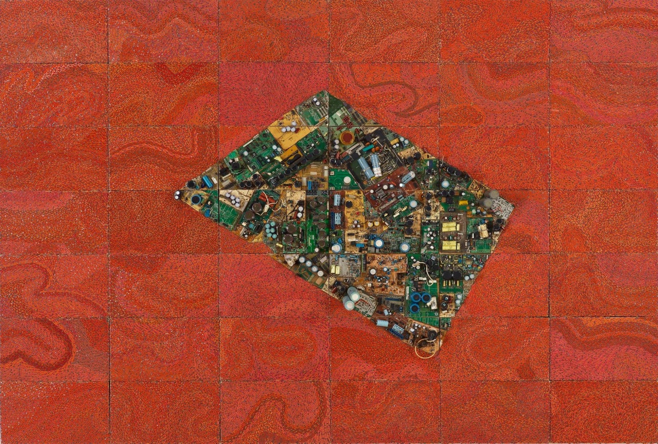 reclaimed electrical wires on a panel creating a quadrangle on a red surface