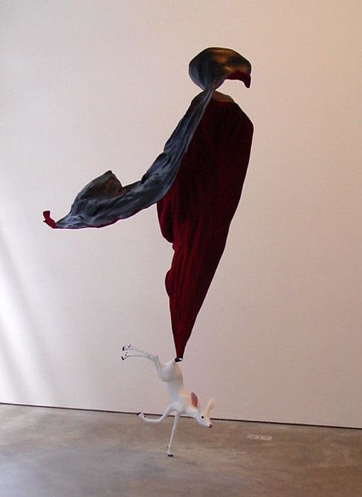 sculpture of a piece of fabric holding up a fawn