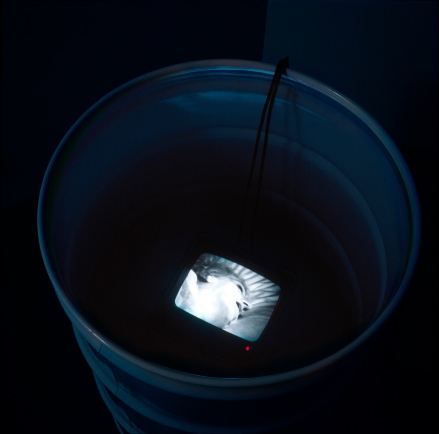 small TV screen inside of a metal barrell