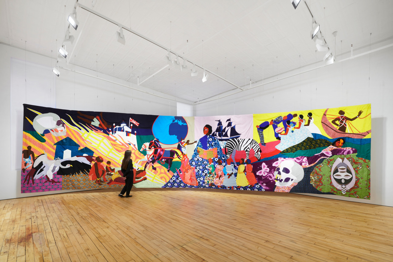 person looking at the large tapestry