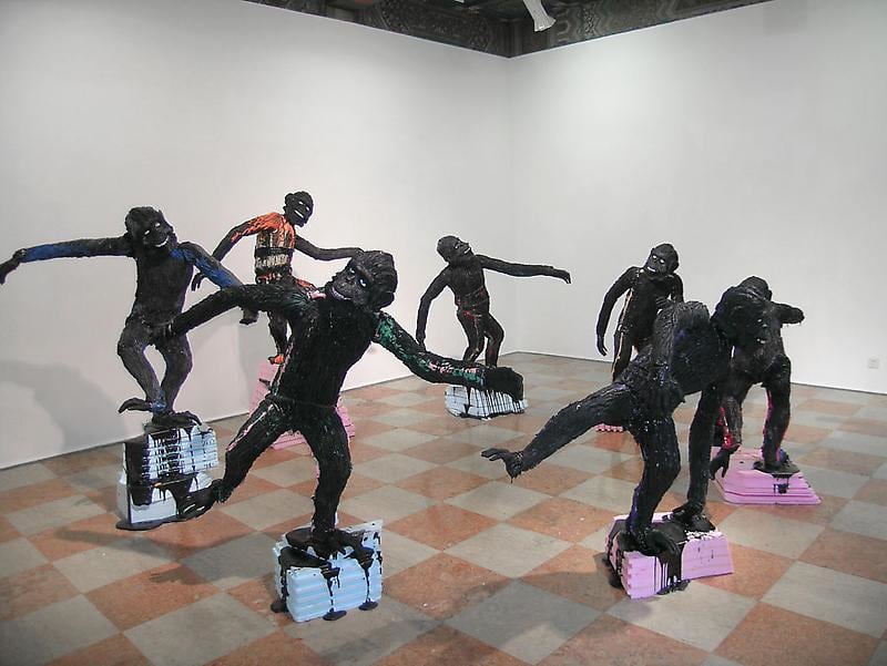 apes standing on pink and blue pedestals