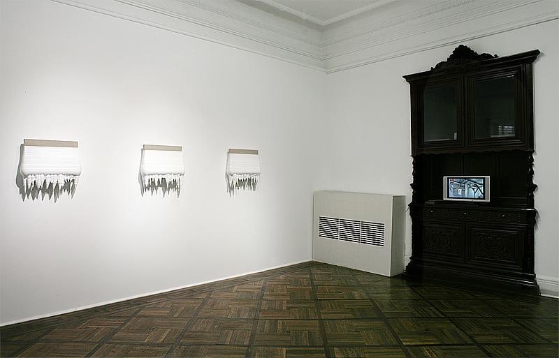 installation view of canvas covered in thick, white paint