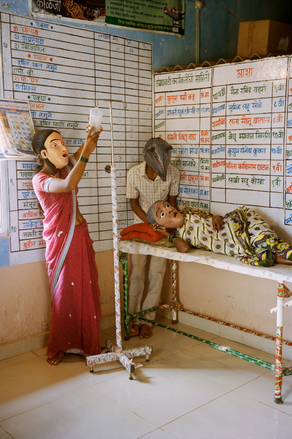 Archival pigment print featuring three people in paper Mache masks
