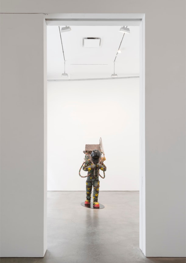 exhibition entrance looking at a sculpture of a deep sea diver or an astronaut