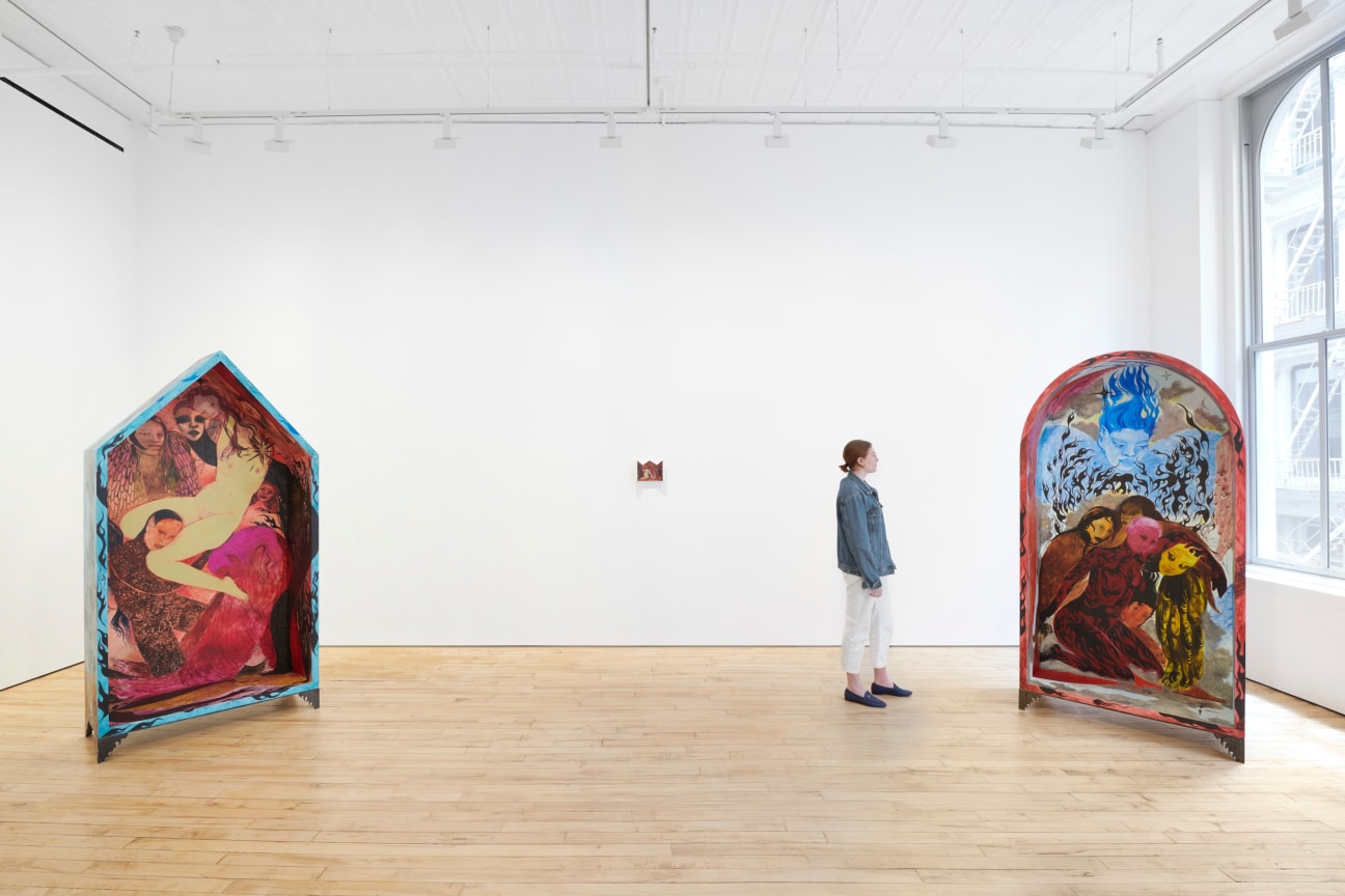 person looking at one of three artworks