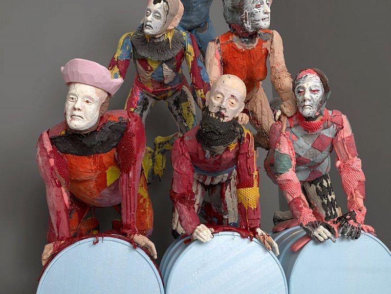 close up of bottom row of the human pyramid, they look very unhappy