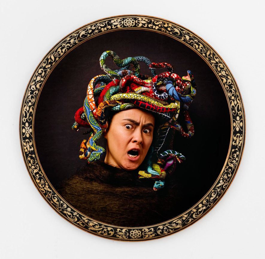the head of a screaming woman with colorful snakes for hair