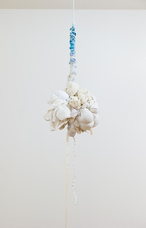white bundle of cloth hanging from the ceiling