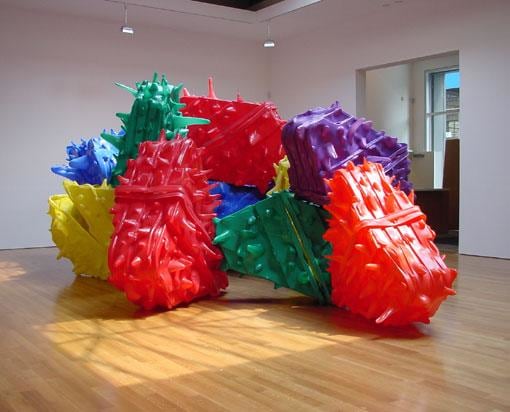 Image of spikey objects of varying colors colliding