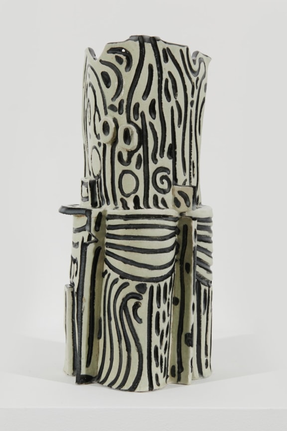 white sculpture with black streaks all over it