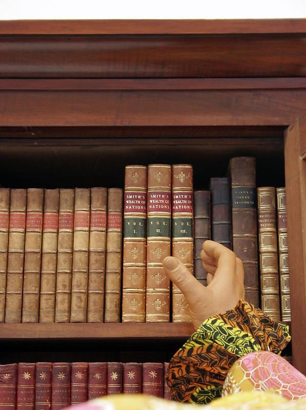 mannequin's hand reaching out for a book