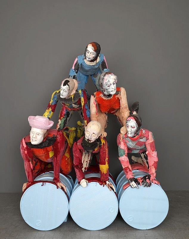 statues forming a human pyramid