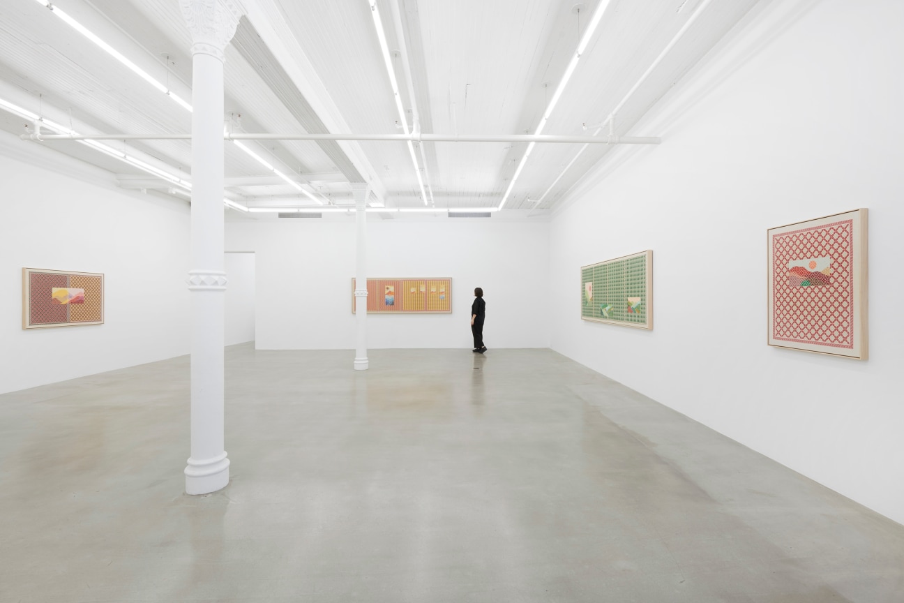 figure moving through white gallery with four embroidered artworks