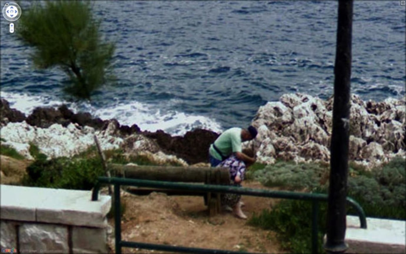 photograph of two people by the water
