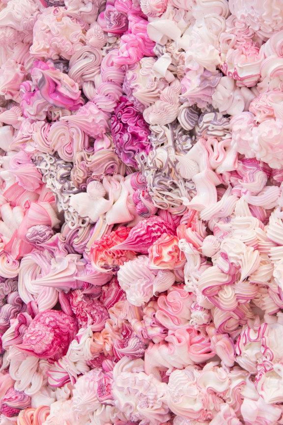 dollops of pink, purple, and white whipped cream substances packed together