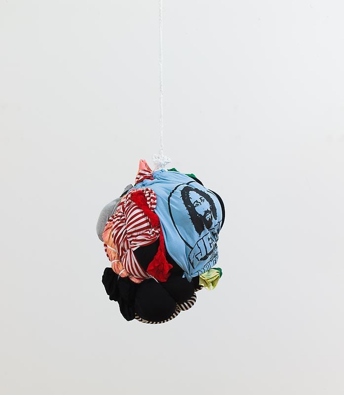 bundle of clothes hanging from a ceiling